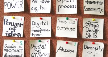 Corkboard with inspiring notes and goals pinned, emphasizing creativity and innovation.