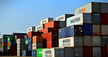 Colorful stacked shipping containers at a port exemplify global logistics.